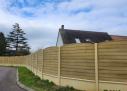 Dolleans Service installe une clôture Mur Plaque imitation Bois à Gasny dans le 27